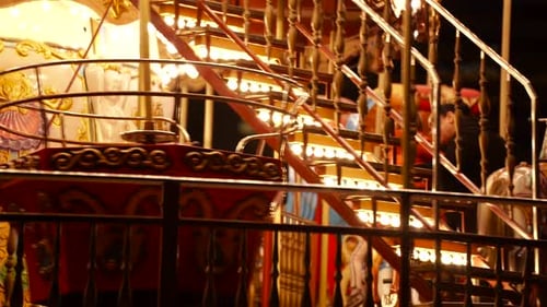 Carousel roundabout or merry-go-round with children having fun at festive night