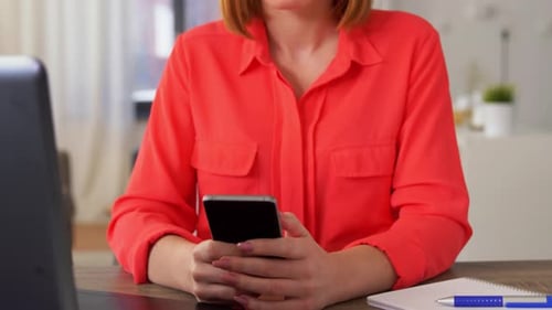 Frustrated Woman with Phone Shakes Head Indoors