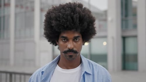 Smiling Man with Afro Close Up in Urban Setting