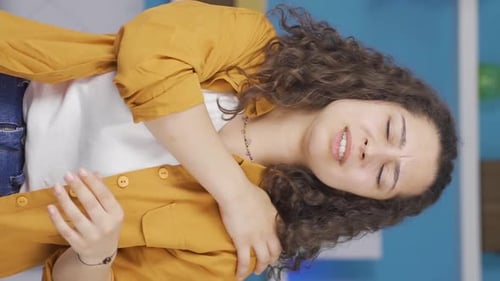 Young Woman Massaging Sore Shoulder in Home