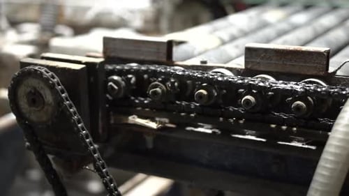Machinery Chain Rotating Gear in a Factory Setting