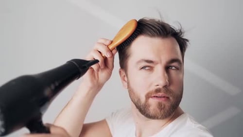 Bearded Man Brushing and Drying Hair