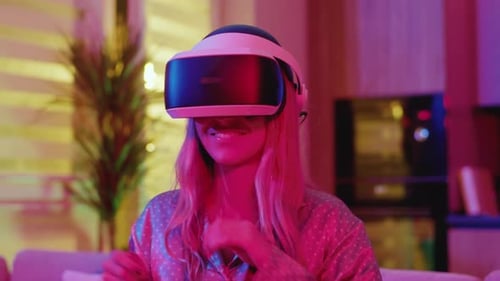 Young Woman Uses VR Headset at Home at Night