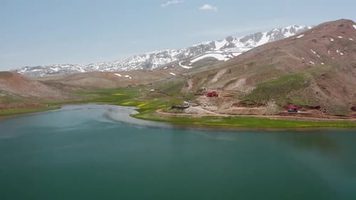 Aerial Video of Lake Nestled in Winter Mountain Range Drone
