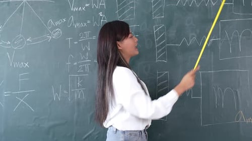 Young Teacher Explaining Science on Chalkboard