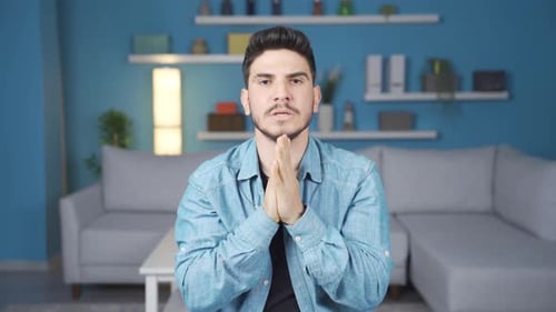 Man looking worried and stressed looking at camera.