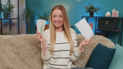 Excited Woman Celebrates Financial Win at Home