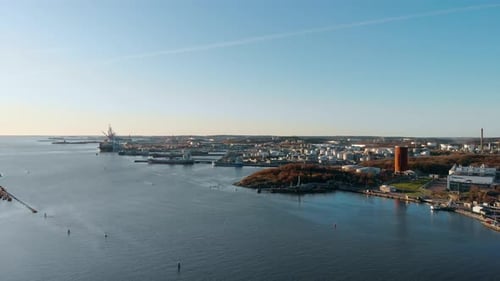 Drone dolly move with aerial view of inlet of the port of Gothenburg, Sweden during late afternoon.