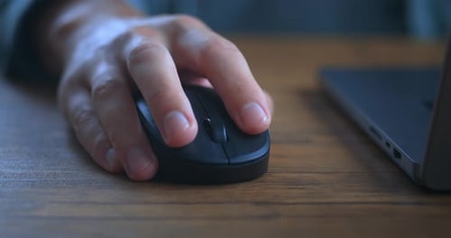 Close Up Male Hand Click Black Computer Mouse on Work Desk