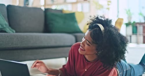 Woman with Laptop and Headphones in Home