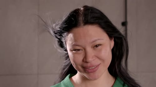 Woman Drying Hair with Hairdryer in Close Up