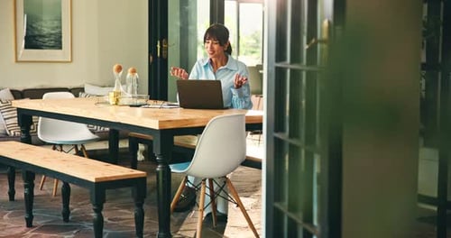Woman Working on Laptop at Home at Table