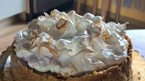 Toasting Meringue Cake Frosting Using Blowtorch. closeup shot