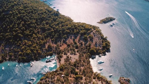 Aerial drone flying over the mediterranean sea with sailing boats, yachts in the bay lagoon. Golden