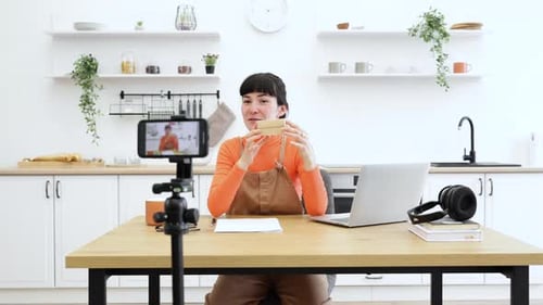 Woman Unboxing a Package in Her Modern Kitchen