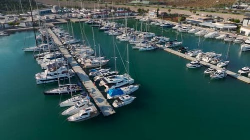Crowded Yacht Marina Showcasing Sailboats Speedboats and Luxurious Vessels in Turquoise Waters