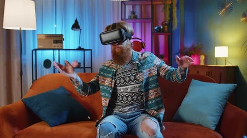 Man Wearing VR Headset on Couch at Home