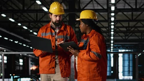 Professional Engineers Team Coordinating Production Line in Largescale Factory