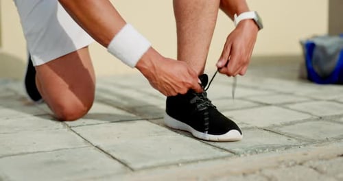 Man, hands and shoe lace tie in city fitness, workout or training for healthcare wellness