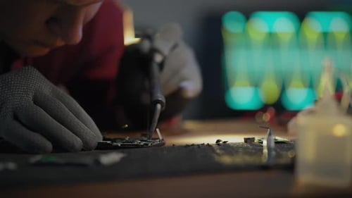 Technician Repairing Electronic Circuit Board Close Up