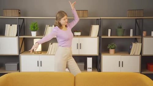 Woman Dances Joyfully in her Home Living Room