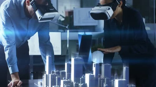 Male and Female Architects Wearing Augmented Reality Headsets Work with 3D City Model. High Tech O