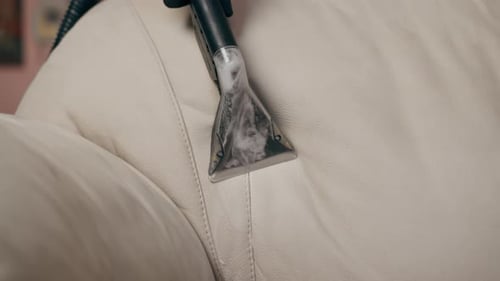 Close Up Professional Cleaning of an Apartment Cleaner Vacuuming with Detergent Textile Sofa