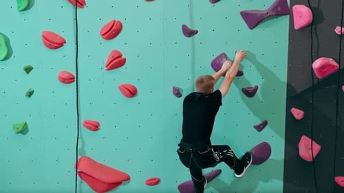 Young Adult Climbing on Climbing Wall