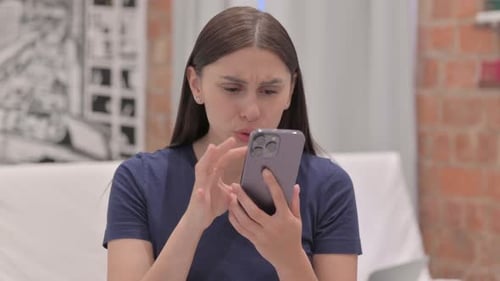 Upset Woman Reacts to Mobile Phone