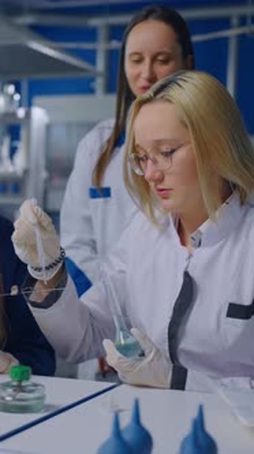 Female Researchers Conduct Experiment in Modern Laboratory