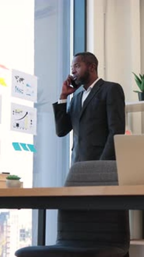 Man On Phone With Charts