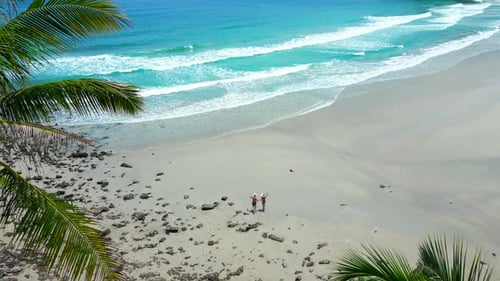 Happy Young Couple Enjoys Summer Vacation on an Empty Tropical Beach in Thailand