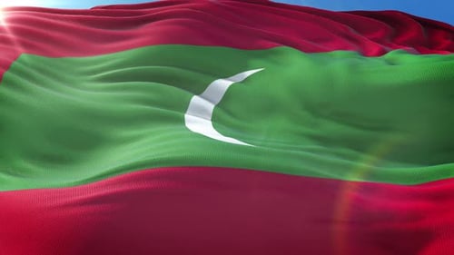 Realistic Waving Maldives Flag Against Blue Sky Background