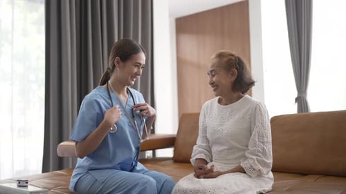 Nurse Listens to Senior Woman's Heart at Home