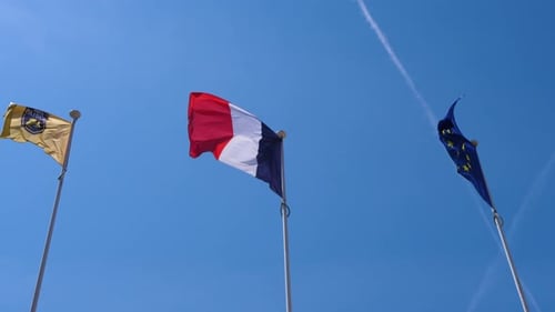 Three Flags Waving in the Wind on a Summer Day