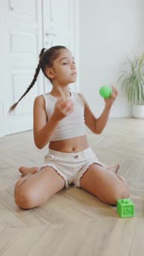 Child Engaging in Play Therapy Toss Balls in a Bright Modern Room During Afternoon Sessionvertical