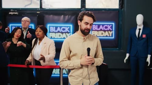 Man Announces Black Friday Sales at Shop Opening