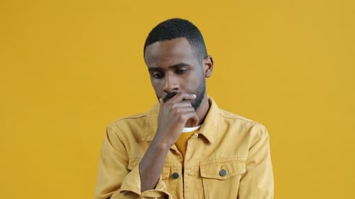 Portrait of Pensive AfroAmerican Guy Thinking Then Raising Finger Enjoying Brilliant Idea