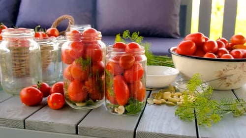 Tomatoes Ready for Canning with Jars and Herbs