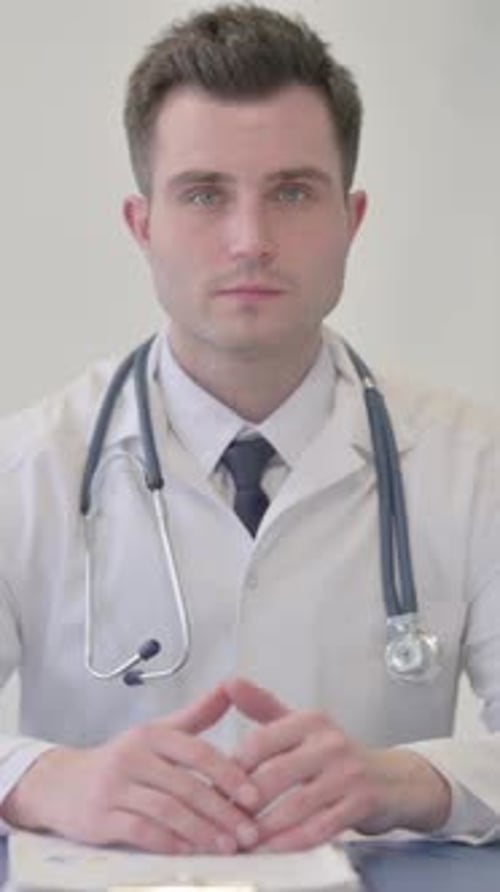 Young Doctor Looking at the Camera in Clinic, vertical video