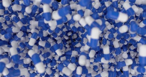 Blaue und weiße Kapseln, die auf Alpha fallen