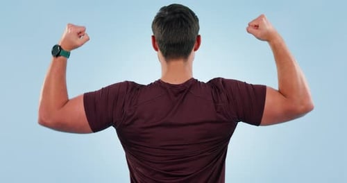 Man, fitness and flexing strong muscle in studio with bodybuilder strength