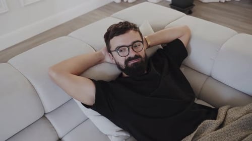 Man Relaxing Comfortably on Couch at Home