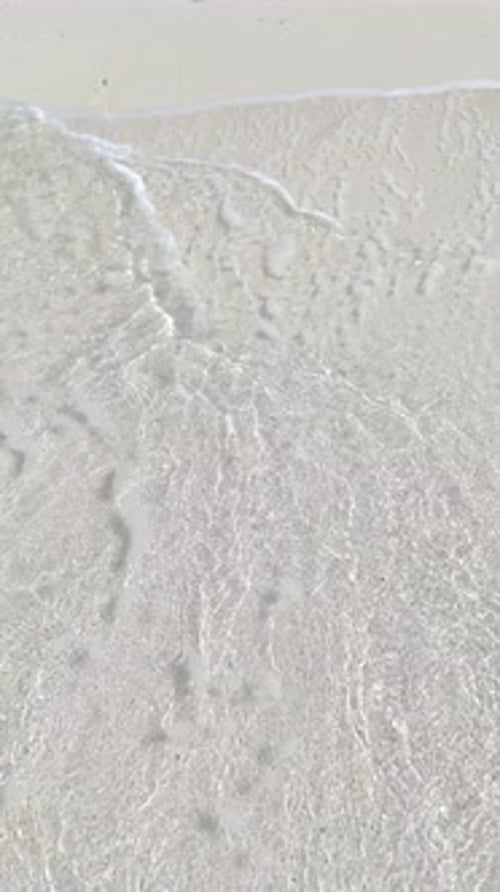 Top View of Tropical Beach with White Sand and Clear Blue Ocean Turquoise Water in Natural Sunlight