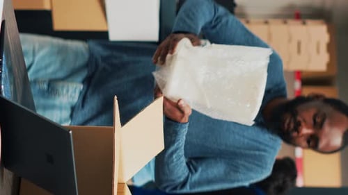 Vertical Video Male Entrepreneur Analyzing Boxes with Products to Ship Order to Customers