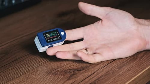 Pulse Oximeter Monitoring on Finger in Close Up