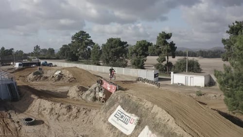 Motorbike speeding on dirt close up. Dirt flying behind the motocross racer while speeding on track.