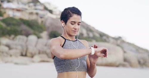 Fitness, smart watch and woman on the beach for running with race, marathon or competition training