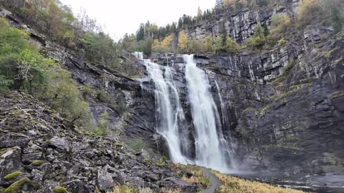 Skjervsfossen Waterfall in Norway, Waterfall with mountains