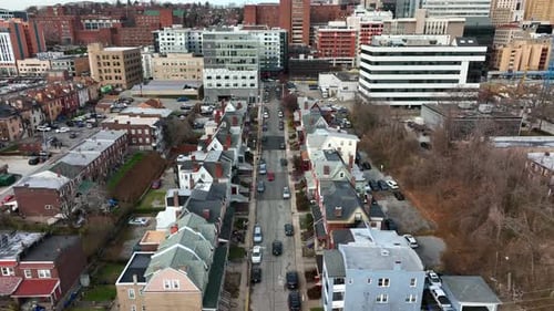 Descending aerial. Urban city in USA establishing shot in daytime winter scene.